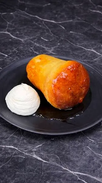 Babà napoletano servito con crema